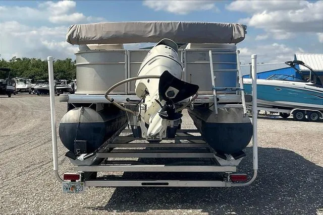 Slide: The Image of 2016 Sweetwater SW 2286 pontoon boat on trailer, rear view, parked outdoors. - 6