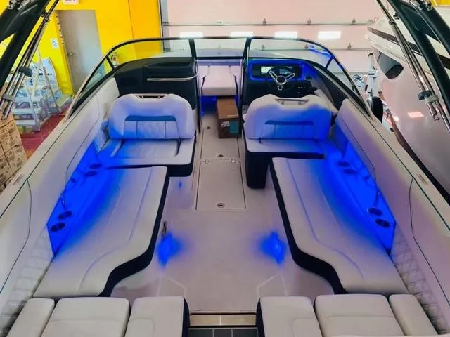 Slide: The Image of 2022 Regal LS6 boat interior with blue LED lighting and luxurious seating. - 4