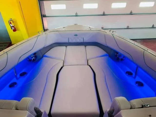 Slide: The Image of 2022 Regal LS6 boat interior with blue LED lighting and cushioned seating. - 6