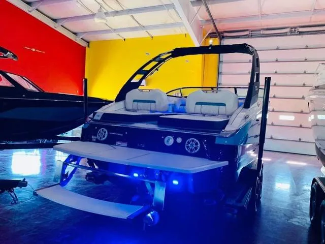 Slide: The Image of 2022 Regal LS6 boat in showroom with vibrant red and yellow walls. - 8