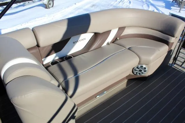 Slide: The Image of 2019 Sylvan S3 boat interior with beige seating and cup holders. - 12