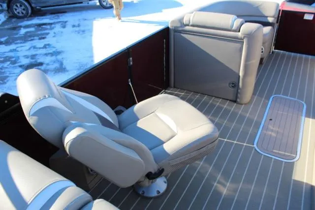 Slide: The Image of 2019 Sylvan S3 boat interior with gray seating and striped flooring. - 14