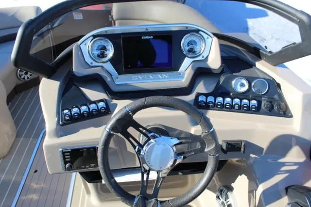 Slide: The Image of 2019 Sylvan S3 boat dashboard with steering wheel and control panel. - 16