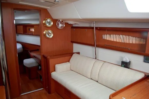 Slide: The Image of Interior of 2008 Beneteau Oceanis 49 yacht with cozy seating and wooden finishes. - 6