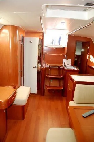 Slide: The Image of Interior of 2008 Beneteau Oceanis 49 yacht with wooden furnishings and seating area. - 7