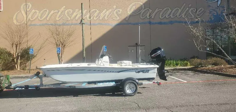 The Image of 2025 Mako Pro Skiff 15 CC boat on trailer in parking lot. - 0