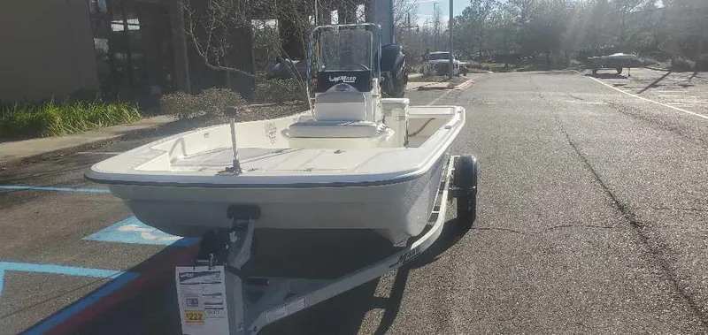 Slide: The Image of 2025 Mako Pro Skiff 15 CC boat on trailer in parking lot. - 4