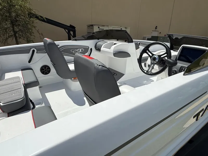 Slide: The Image of 2025 Tahoe T21 boat interior with modern seating and steering wheel. - 2