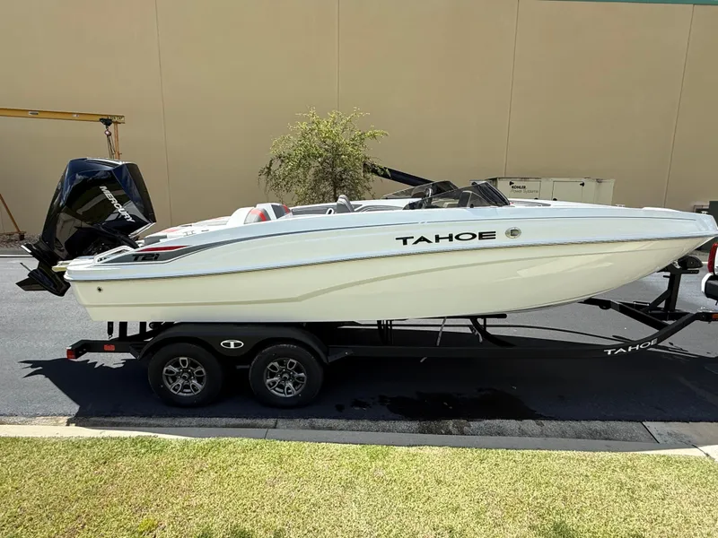 Slide: The Image of 2025 Tahoe T21 boat on trailer, white hull, parked outdoors. - 3
