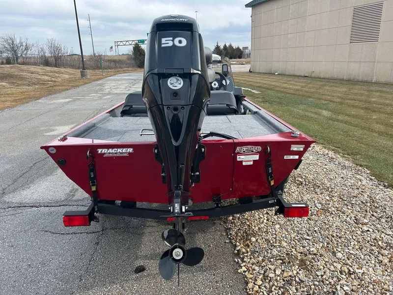Slide: The Image of 2025 Tracker Bass Tracker Classic XL boat with 50 HP engine, parked outdoors. - 2