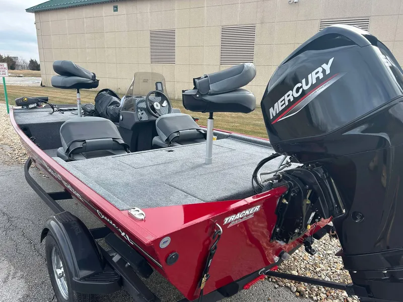 Slide: The Image of 2025 Tracker Bass Tracker Classic XL boat with Mercury engine, parked outdoors. - 3