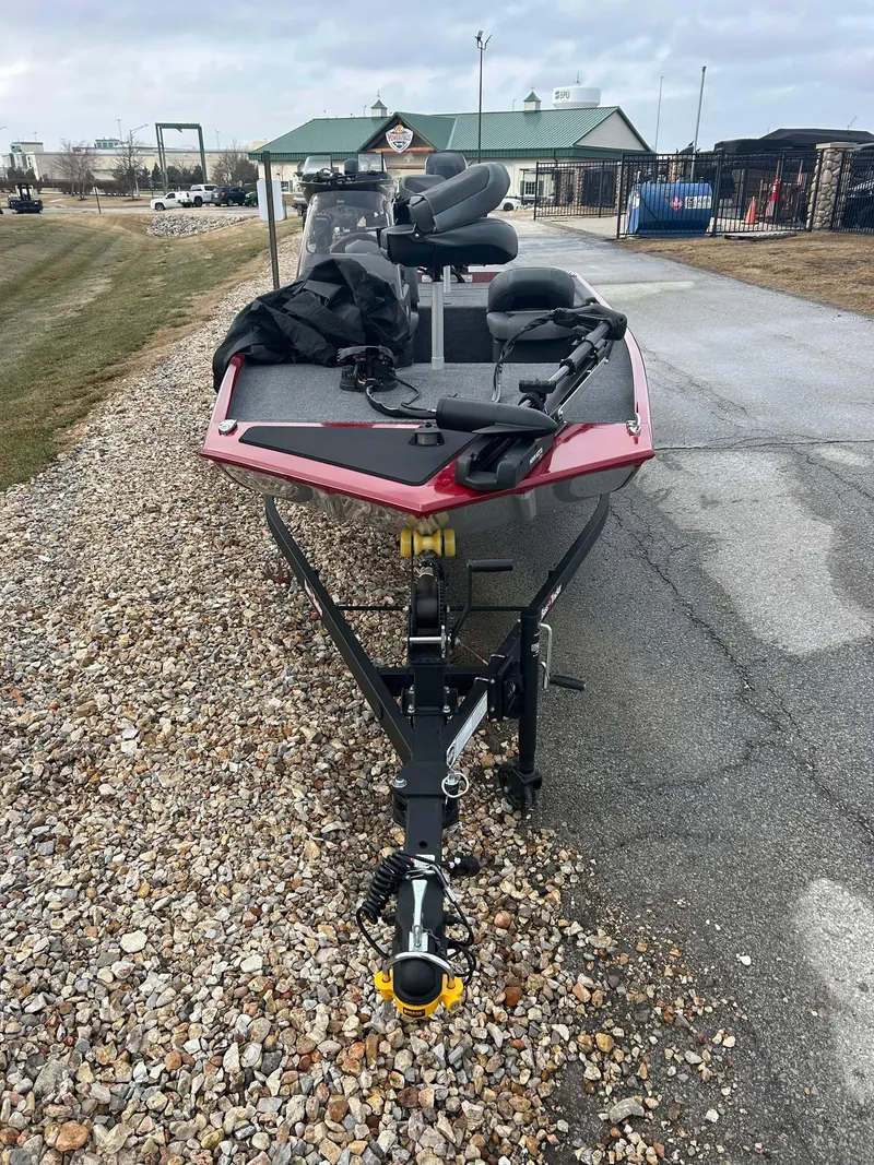 Slide: The Image of 2025 Tracker Bass Tracker Classic XL boat on a trailer, parked on gravel. - 5