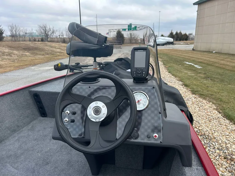 Slide: The Image of 2025 Tracker Bass Tracker Classic XL boat dashboard with steering wheel and navigation system. - 7