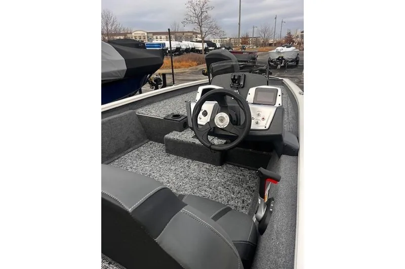 Slide: The Image of 2025 Tracker Pro Team 175 boat interior with steering wheel and dashboard controls. - 61