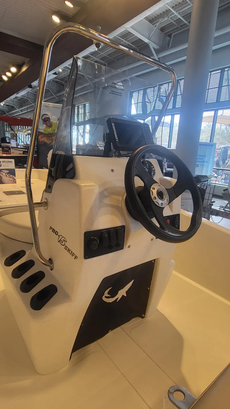 Slide: The Image of 2025 Mako Pro Skiff 15 CC boat console with steering wheel and controls. - 6