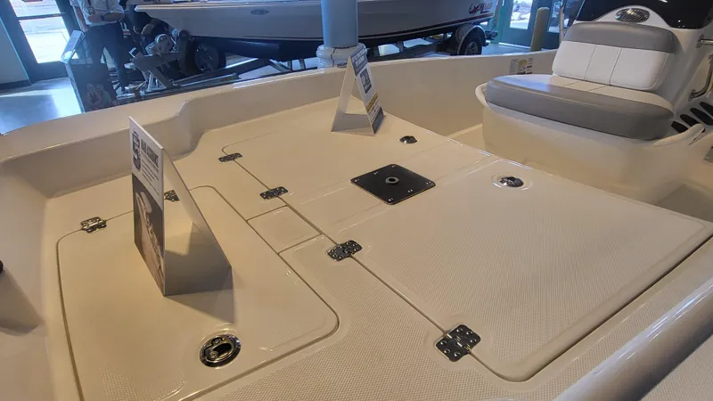 Slide: The Image of 2025 Mako Pro Skiff 15 CC boat interior with seating and storage compartments. - 7