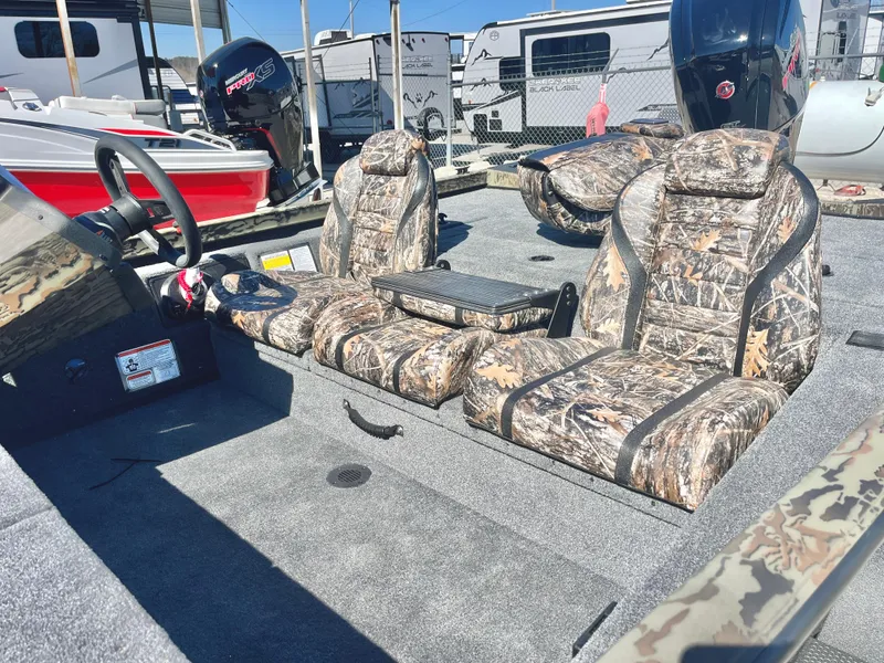 Slide: The Image of 2025 Ranger RT188 boat interior with camouflage seats and steering wheel. - 11
