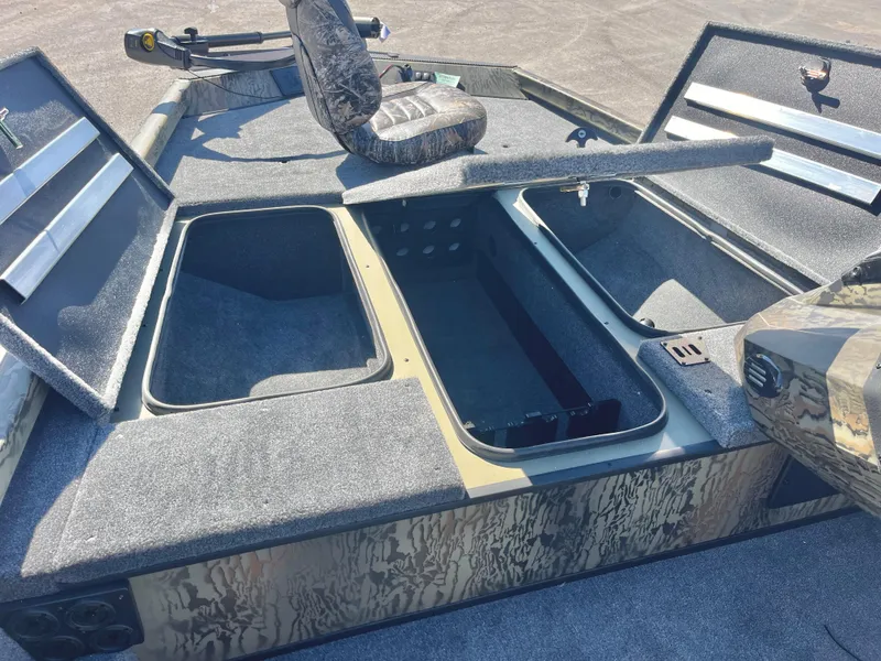 Slide: The Image of 2025 Ranger RT188 boat with open storage compartments and camo seating. - 12