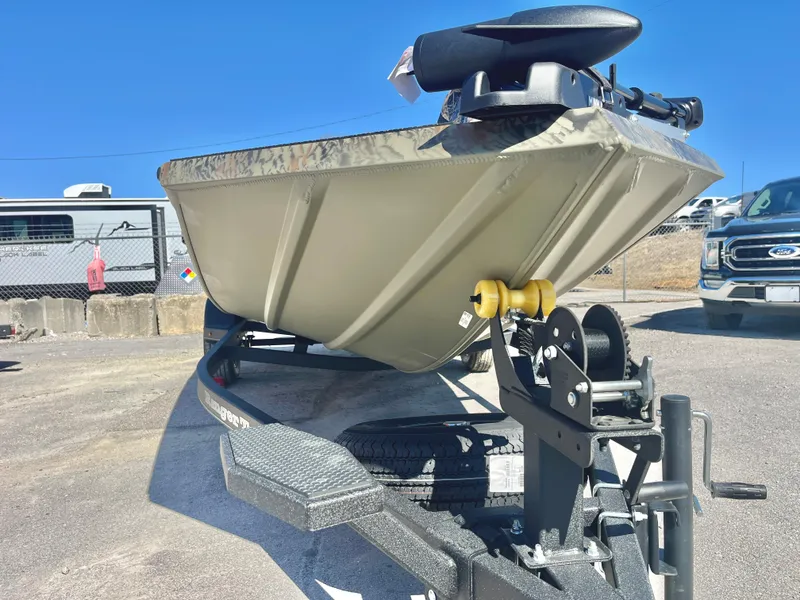 Slide: The Image of 2025 Ranger RT188 boat on trailer, parked outdoors under clear blue sky. - 14