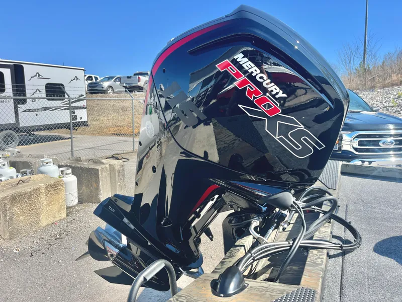 Slide: The Image of 2025 Ranger RT188 with Mercury Pro XS outboard motor in a parking area. - 15