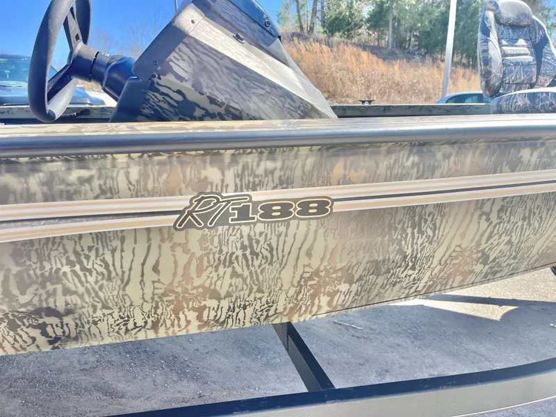 Slide: The Image of 2025 Ranger RT188 boat with camouflage design, steering wheel, and seating visible. - 18