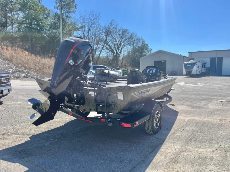 Slide: The Image of 2025 Ranger RT188 boat with motor, parked outdoors on a sunny day. - 5