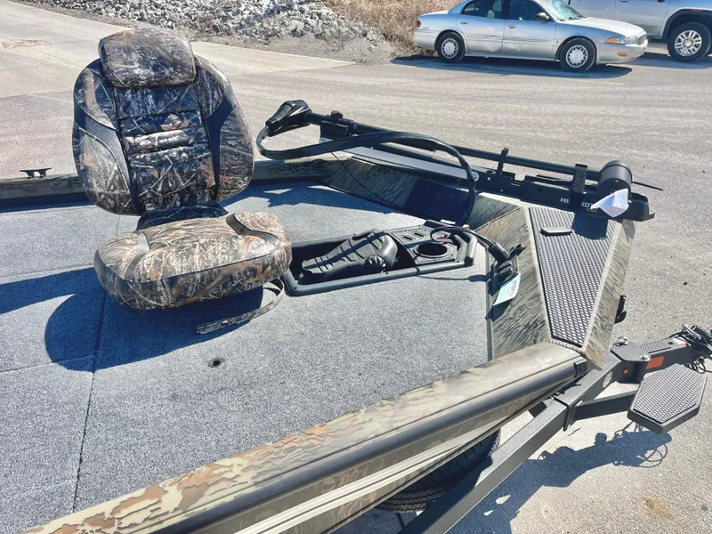 Slide: The Image of 2025 Ranger RT188 boat with camo seat and trolling motor on a sunny day. - 8