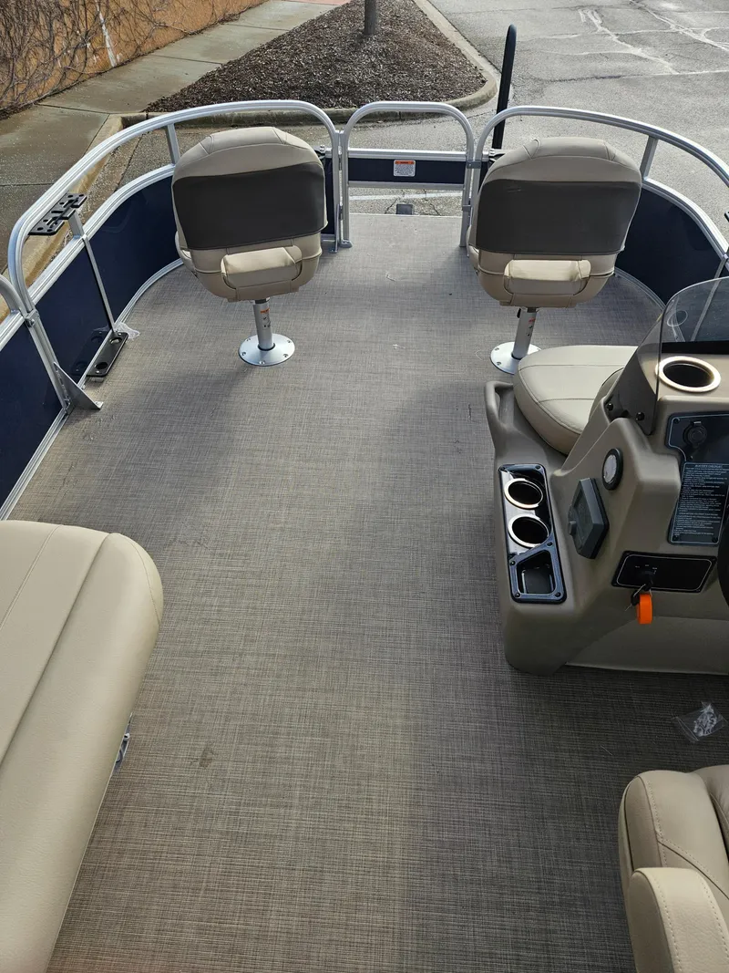 Slide: The Image of 2025 Sun Tracker Bass Buggy 16 XL Select pontoon boat interior with seating and console. - 2