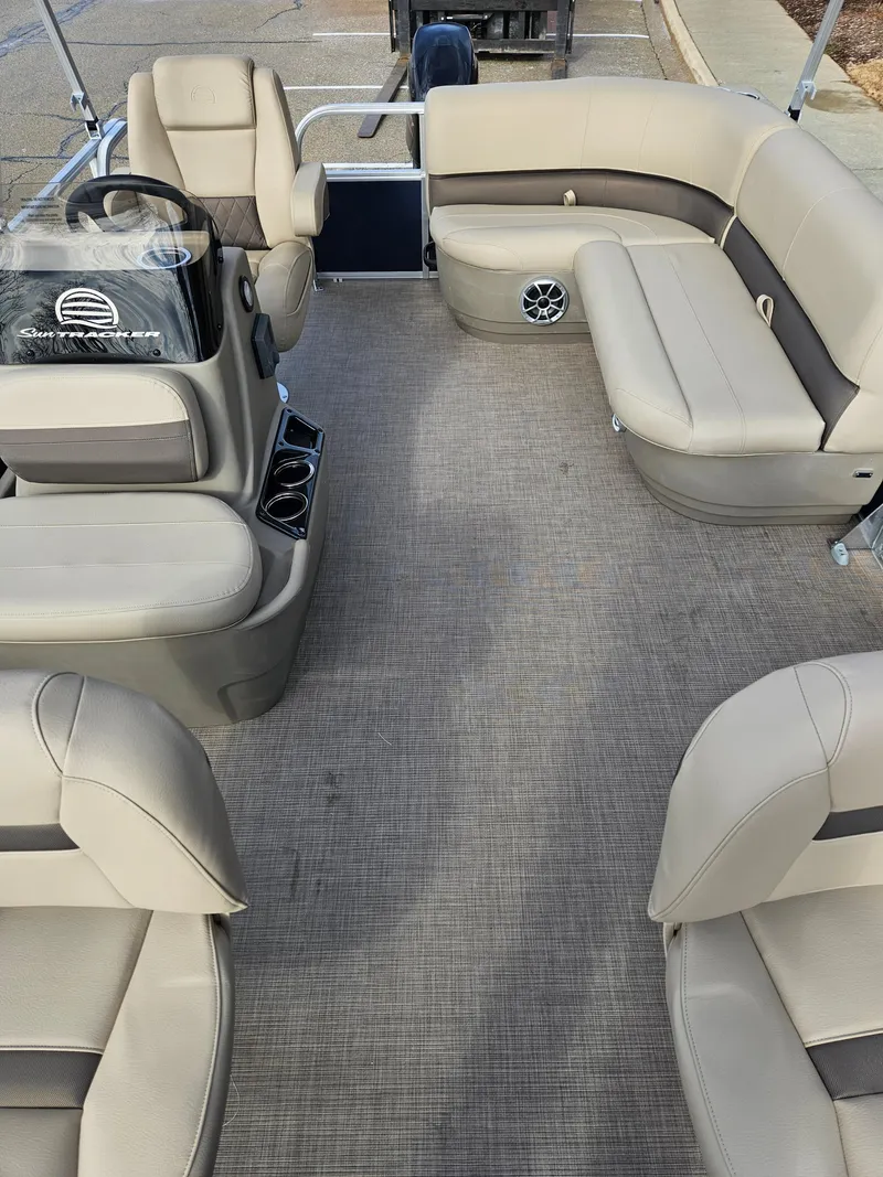 Slide: The Image of 2025 Sun Tracker Bass Buggy 16 XL Select pontoon boat interior with beige seating. - 3