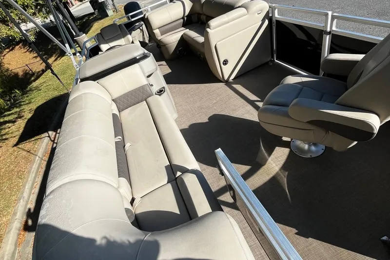 Slide: The Image of 2025 Sun Tracker SportFish 20 DLX pontoon boat interior with plush seating and spacious layout. - 5