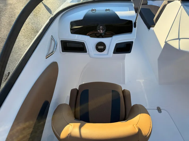 Slide: The Image of 2025 Tahoe 200 S boat interior with tan and black seating, modern dashboard. - 10