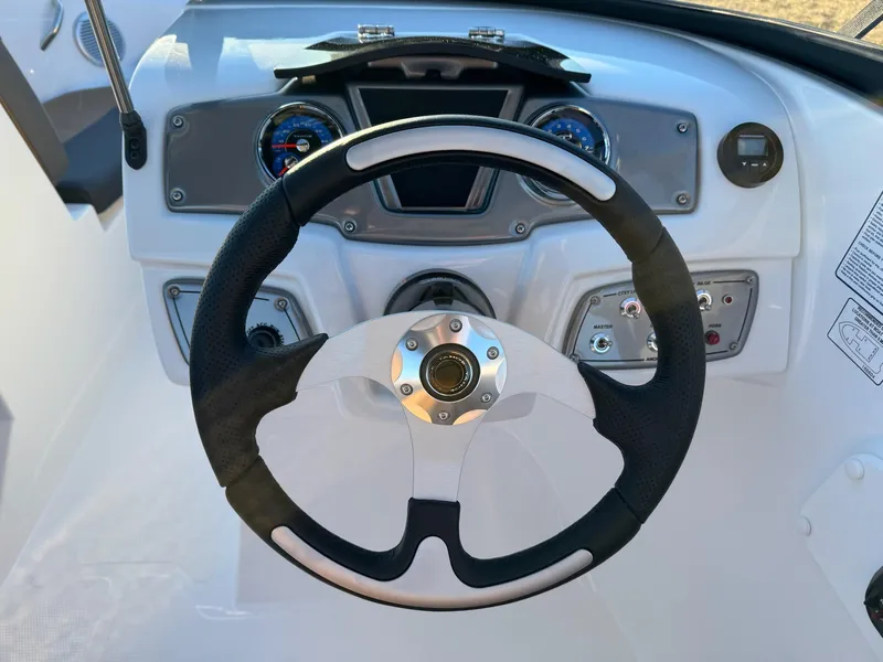 Slide: The Image of Steering wheel and dashboard of 2025 Tahoe 200 S boat, featuring modern controls and gauges. - 3