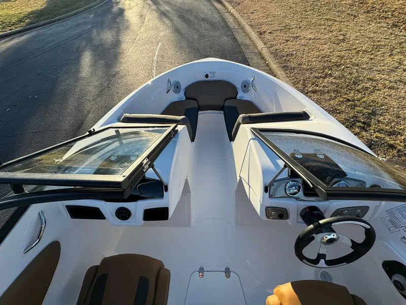 Slide: The Image of 2025 Tahoe 200 S boat interior with open windshield, steering wheel, and seating. - 6