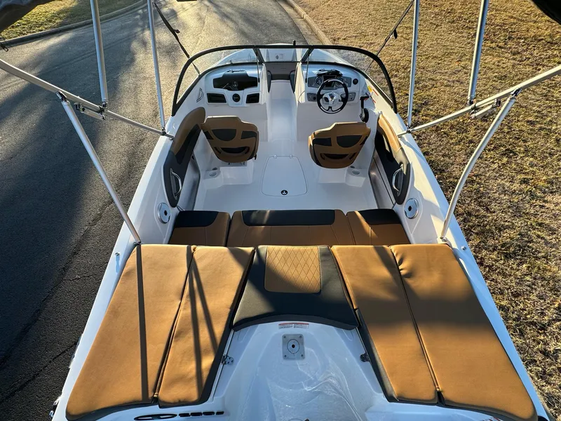 Slide: The Image of 2025 Tahoe 200 S boat interior with tan seating and steering console. - 7