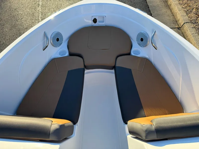 Slide: The Image of 2025 Tahoe 200 S boat interior with cushioned seating and cup holders. - 8