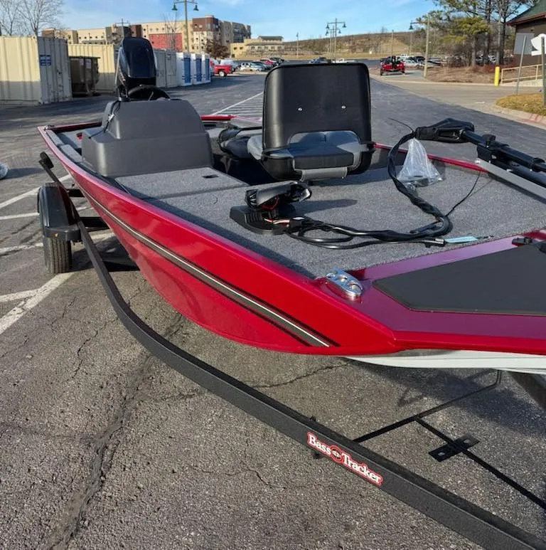 Slide: The Image of 2025 Tracker Bass Tracker Classic XL boat, red exterior, parked on a trailer in a lot. - 3