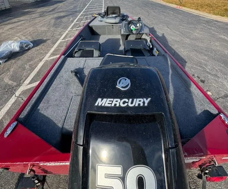 Slide: The Image of 2025 Tracker Bass Tracker Classic XL boat with Mercury 50 engine, parked on pavement. - 5