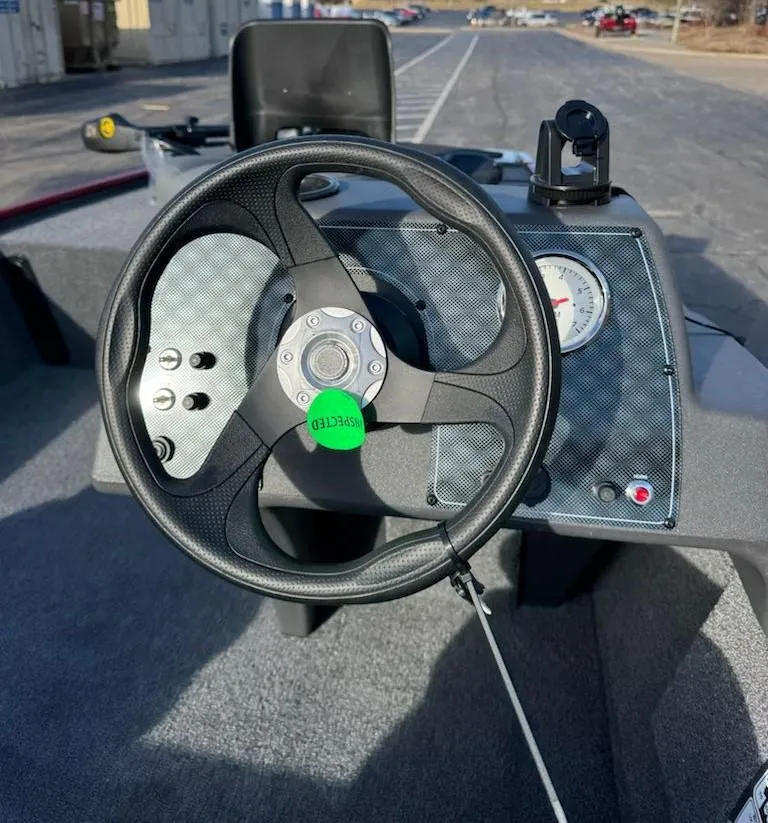 Slide: The Image of Steering wheel of 2025 Tracker Bass Tracker Classic XL boat, featuring dashboard controls. - 7