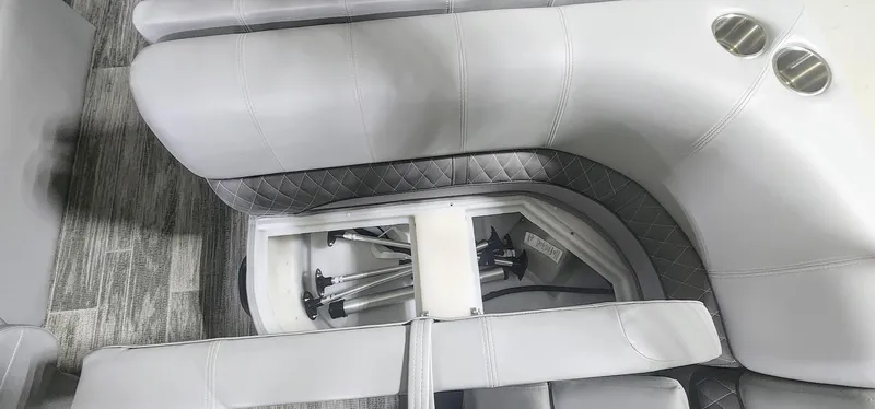 Slide: The Image of 2025 Ranger Reata 220F boat interior with storage compartment and cup holders. - 10