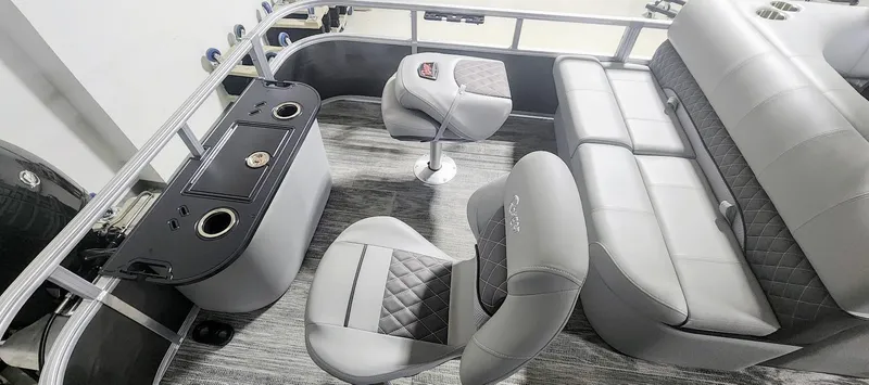 Slide: The Image of 2025 Ranger Reata 220F boat interior with gray seating and console. - 14