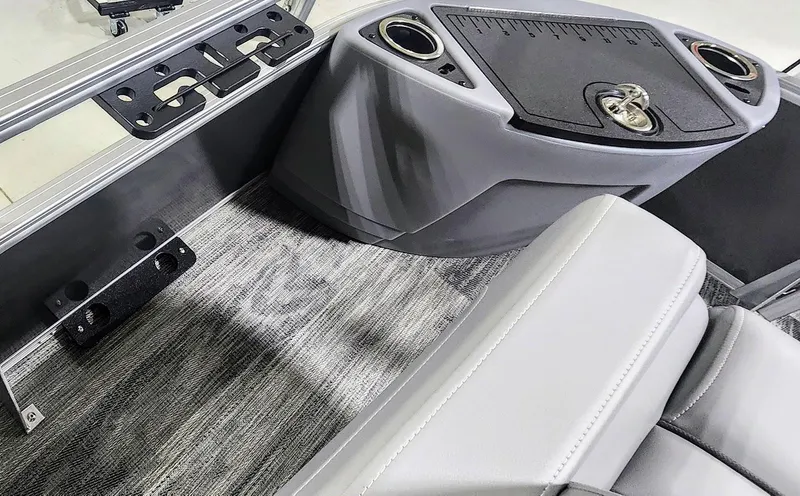 Slide: The Image of 2025 Ranger Reata 220F boat interior with gray seating and console details. - 5