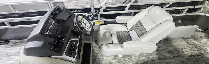 Slide: The Image of Captain's chair and console of 2025 Ranger Reata 220F boat, featuring modern controls and design. - 6