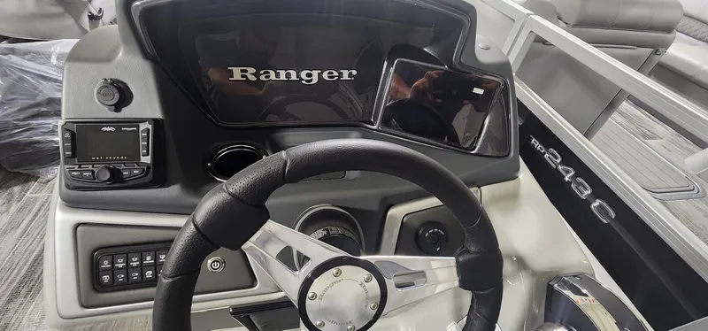 Slide: The Image of Steering console of 2025 Ranger Reata 220F boat with modern controls and display. - 7