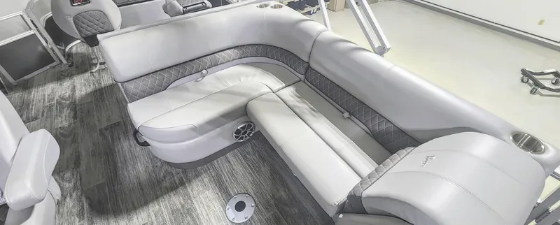 Slide: The Image of 2025 Ranger Reata 220F boat interior with gray seating and wood-style flooring. - 8
