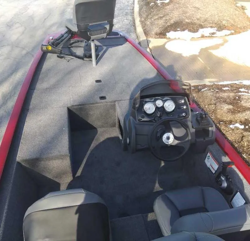 Slide: The Image of 2025 Tracker Pro 170 boat interior with steering console and seating. - 2