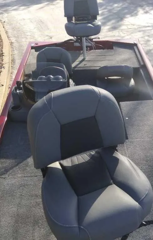 Slide: The Image of 2025 Tracker Pro 170 boat interior with gray seating and steering console. - 3