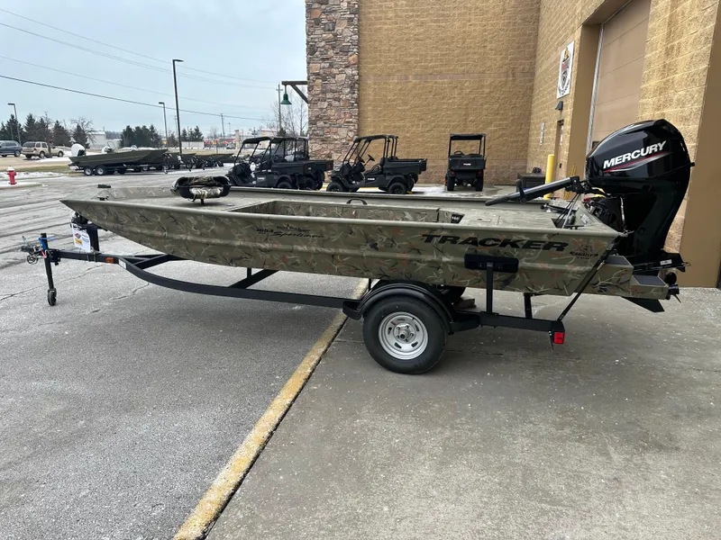 The Image of 2025 Tracker Grizzly 1654 T Sportsman boat on trailer, parked outdoors. - 0