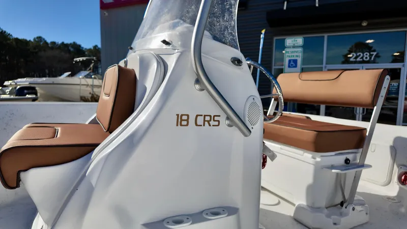 Slide: The Image of 2025 ALK2 Powerboats 18 CRS with tan seating and sleek design. - 12