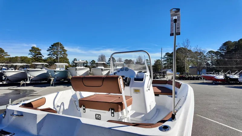 Slide: The Image of 2025 ALK2 Powerboats 18 CRS with brown seating, parked outdoors under clear blue sky. - 6