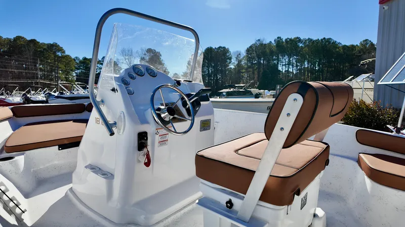 Slide: The Image of 2025 ALK2 Powerboats 18 CRS interior with steering console and cushioned seating. - 8